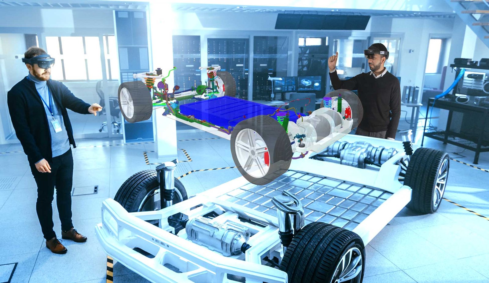 A team of engineers reviewing a car chasis using the Microsoft HoloLens 2.