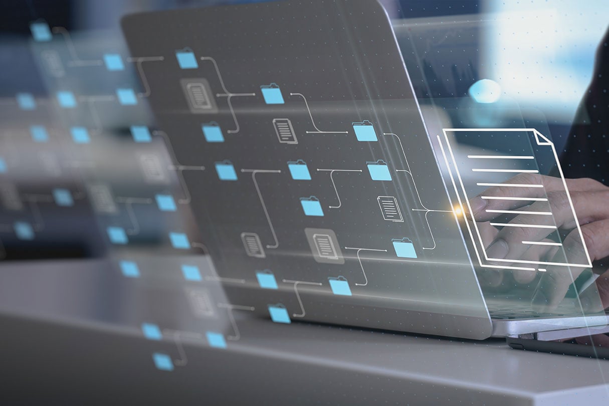 An image of a laptop with various data sources displayed graphically.