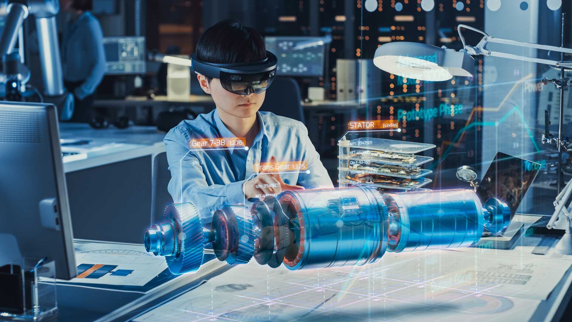 Factory engineer wearing Augmented / Mixed reality headset to review design of electric motor prototype